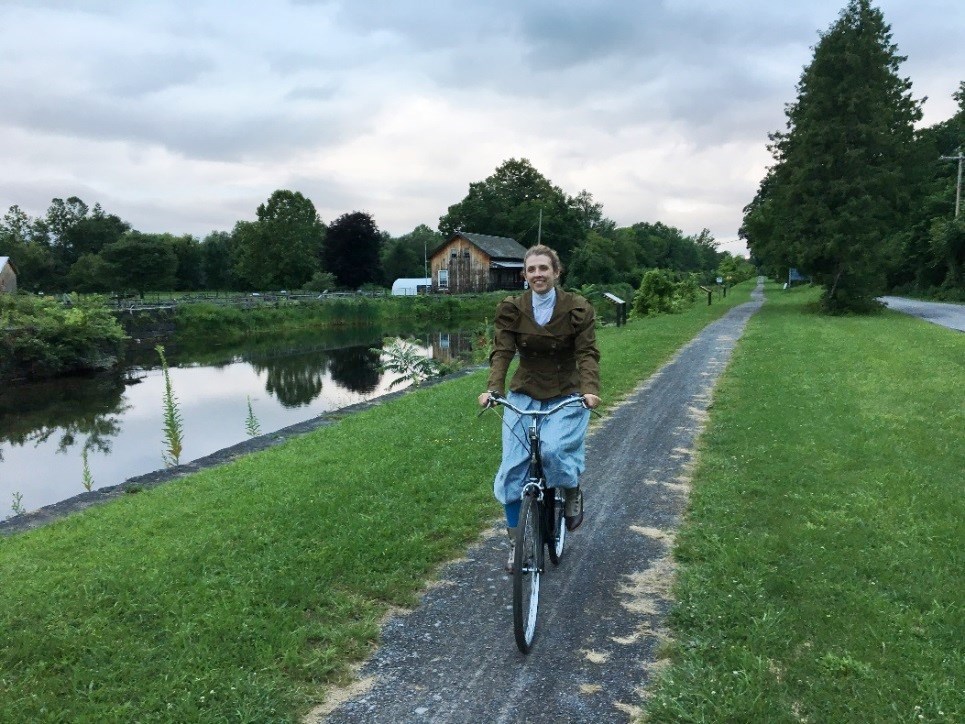 Author Kjirsten Gustavson on her 1963 Raleigh bicycle at the Erie Canal Boat Landing Museum lighter
