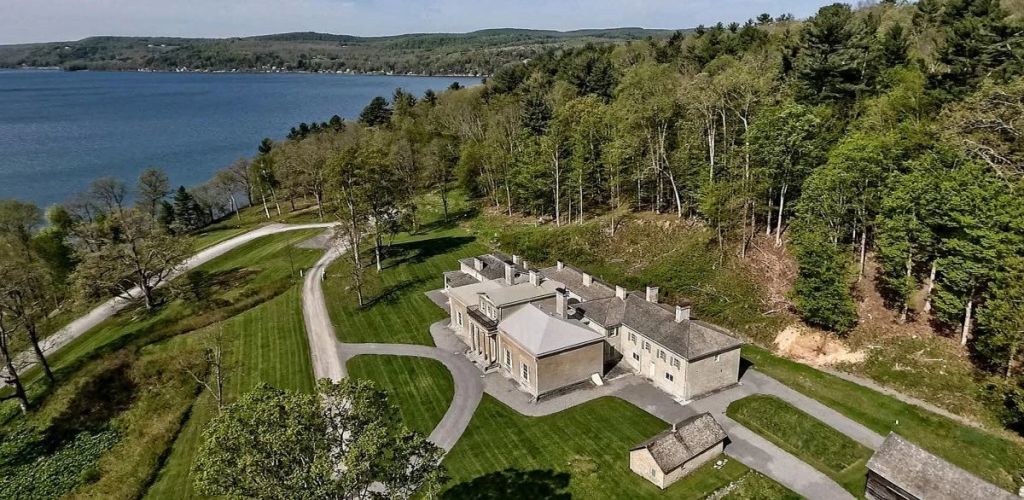 Aerial view of Hyde Hall, a historic estate near Otsego Lake, surrounded by trees and a manicured lawn.