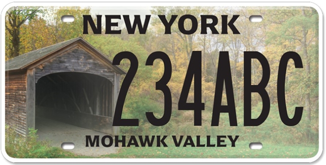 Image of a New York license plate featuring a covered bridge, labeled 'NEW YORK' at the top, a random sequence of letters and numbers, and 'MOHAWK VALLEY' at the bottom, set against a backdrop of trees in fall colors.